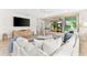 Light and airy living room with a large sectional sofa and sliding doors to patio at 8725 Sundance Loop, Sarasota, FL 34238