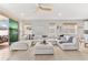 Open living area with a comfortable sectional sofa and sliding glass doors at 8725 Sundance Loop, Sarasota, FL 34238