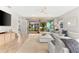 Open living area featuring a large sectional sofa and view of the backyard at 8725 Sundance Loop, Sarasota, FL 34238
