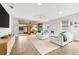 Spacious living room with white sectional sofa and access to backyard patio at 8725 Sundance Loop, Sarasota, FL 34238