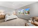 Bright main bedroom with large windows and plush carpet at 8725 Sundance Loop, Sarasota, FL 34238