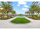 Community pool with lush landscaping and palm trees at 8725 Sundance Loop, Sarasota, FL 34238