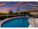 Screened pool and patio with tranquil sunset view at 9441 Cedar Ridge Ln, Sarasota, FL 34238