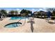 Community pool and spa with lounge chairs and tables at 9441 Cedar Ridge Ln, Sarasota, FL 34238