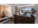 Custom wet bar with a view of the pool and golf course at 9441 Cedar Ridge Ln, Sarasota, FL 34238