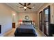 Charming bedroom with a ceiling fan and en-suite bathroom at 951 Fish Hook Cv, Bradenton, FL 34212