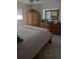 Main bedroom with bamboo furniture and neutral colored bedding at 1002 Oakleaf Blvd, Bradenton, FL 34208