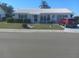 Single-story home with a landscaped lawn and driveway at 1002 Oakleaf Blvd, Bradenton, FL 34208