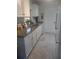 Modern kitchen with white cabinets, granite counters, and stainless steel appliances at 1002 Oakleaf Blvd, Bradenton, FL 34208