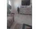 Bright living room with tiled floors, comfy seating, and large TV at 1002 Oakleaf Blvd, Bradenton, FL 34208