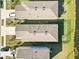 Aerial view of two houses with yards and driveways at 10435 Ladybug Cv, Parrish, FL 34219