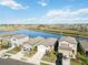 Aerial view of houses near a lake with a beautiful landscape at 10435 Ladybug Cv, Parrish, FL 34219