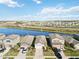 Aerial view of houses near a lake with a beautiful landscape at 10435 Ladybug Cv, Parrish, FL 34219
