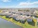 Aerial view of houses with lakefront access at 10435 Ladybug Cv, Parrish, FL 34219