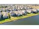 Aerial view of a neighborhood with houses near a lake at 10435 Ladybug Cv, Parrish, FL 34219