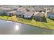 Aerial view of houses and community by the lake at 10435 Ladybug Cv, Parrish, FL 34219