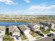 Aerial view of houses near a lake with a beautiful landscape at 10435 Ladybug Cv, Parrish, FL 34219