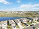 Aerial view of houses near a lake with a beautiful landscape at 10435 Ladybug Cv, Parrish, FL 34219