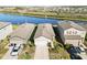 Aerial view of three houses with lake view at 10435 Ladybug Cv, Parrish, FL 34219