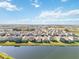 Aerial view of a large neighborhood by a lake at 10435 Ladybug Cv, Parrish, FL 34219