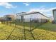 Home's fenced backyard with grassy area at 10435 Ladybug Cv, Parrish, FL 34219