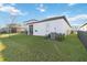 Screened patio and grassy backyard with a privacy fence at 10435 Ladybug Cv, Parrish, FL 34219