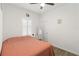 Bright bedroom with a queen bed, window shutters, and wood-look floors at 10435 Ladybug Cv, Parrish, FL 34219