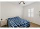 Bedroom with blue and white bedding and window shutters at 10435 Ladybug Cv, Parrish, FL 34219