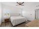 Bright bedroom with king-size bed and wood-look floors at 10435 Ladybug Cv, Parrish, FL 34219