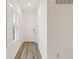 Bright entryway with wood-look floors and white door at 10435 Ladybug Cv, Parrish, FL 34219