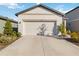 Single-story house with attached garage and neat landscaping at 10435 Ladybug Cv, Parrish, FL 34219