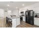 Modern kitchen with island, granite countertops, and black appliances at 10435 Ladybug Cv, Parrish, FL 34219