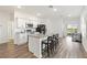 Modern kitchen with white cabinets, granite counters, and island at 10435 Ladybug Cv, Parrish, FL 34219