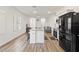 Modern kitchen with a large island and stainless steel appliances at 10435 Ladybug Cv, Parrish, FL 34219