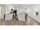 Open kitchen boasts white cabinets and granite countertops at 10435 Ladybug Cv, Parrish, FL 34219