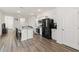 Open concept kitchen with island and black appliances at 10435 Ladybug Cv, Parrish, FL 34219