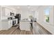Modern kitchen with white cabinets and granite island at 10435 Ladybug Cv, Parrish, FL 34219
