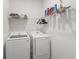 Bright laundry room with washer, dryer, and ample shelving at 10435 Ladybug Cv, Parrish, FL 34219