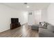 Living room with gray sectional sofa and wood-look floors at 10435 Ladybug Cv, Parrish, FL 34219