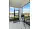 Screened porch with water view and outdoor seating at 10435 Ladybug Cv, Parrish, FL 34219
