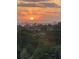 Stunning sunset view overlooking waterfront homes and lush landscape at 1211 Gulf Of Mexico Dr # 301, Longboat Key, FL 34228