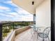 Private balcony with glass table and chairs, offering scenic views at 1211 Gulf Of Mexico Dr # 301, Longboat Key, FL 34228