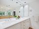 Bright bathroom with double sinks and marble vanity at 1211 Gulf Of Mexico Dr # 301, Longboat Key, FL 34228