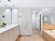 Elegant bathroom with double sinks, soaking tub, and marble at 1211 Gulf Of Mexico Dr # 301, Longboat Key, FL 34228