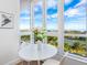 Bright breakfast nook with white table and chairs, and stunning views at 1211 Gulf Of Mexico Dr # 301, Longboat Key, FL 34228