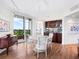 Bright dining area with hardwood floors, built-in bar, and ocean views at 1211 Gulf Of Mexico Dr # 301, Longboat Key, FL 34228