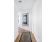 Bright hallway with hardwood floors and built-in storage at 1211 Gulf Of Mexico Dr # 301, Longboat Key, FL 34228