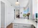 Modern white kitchen with stainless steel appliances and ample storage at 1211 Gulf Of Mexico Dr # 301, Longboat Key, FL 34228
