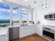 Modern white kitchen with stainless steel appliances and ocean views at 1211 Gulf Of Mexico Dr # 301, Longboat Key, FL 34228