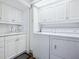 Bright laundry room with white cabinets and washer/dryer at 1211 Gulf Of Mexico Dr # 301, Longboat Key, FL 34228